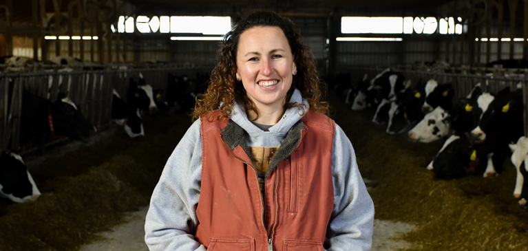 customer in barn with cows in background