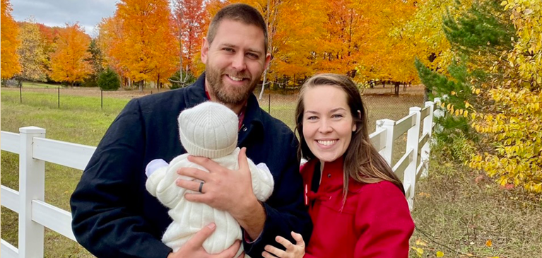 Husband and wife holding baby 