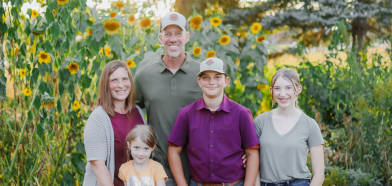 The Sullivan family in front of their sunflowers
