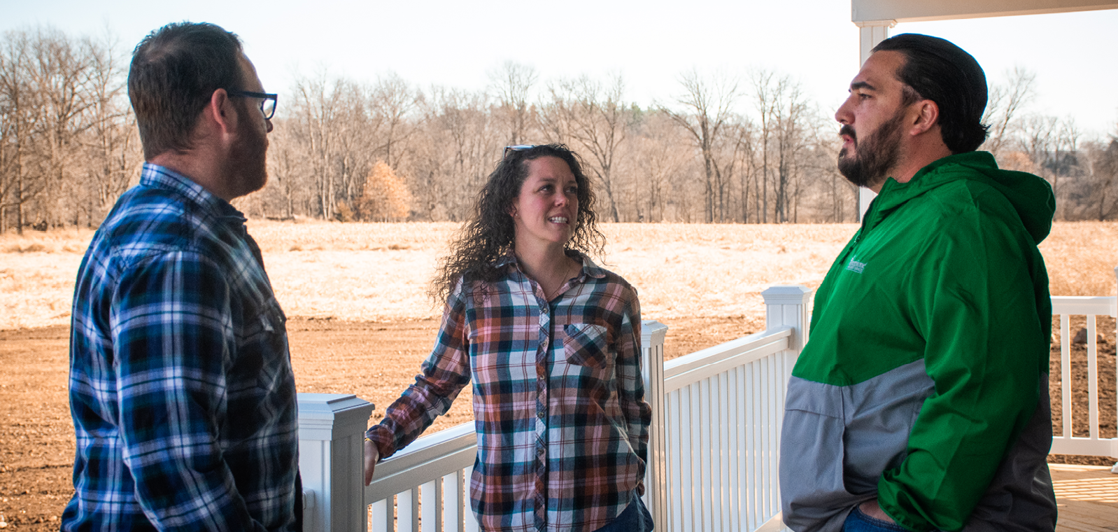 Three people standing and talking